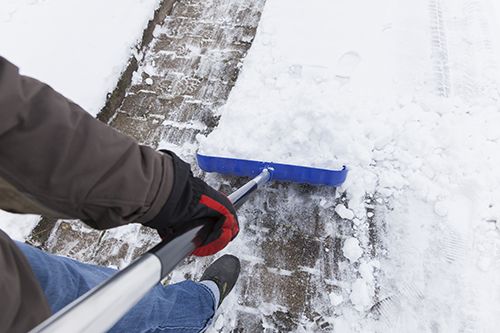First person view of individual shoveling snow